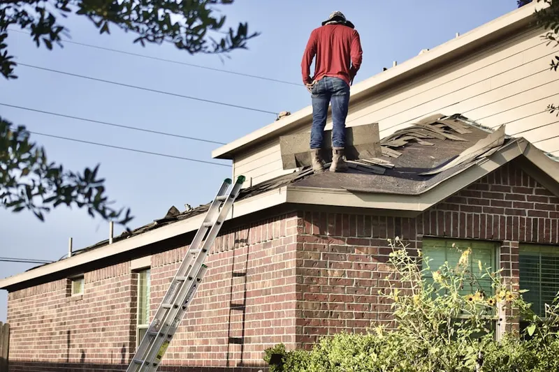 Professional roofer working on a residential roof in Bradenbaugh Manor